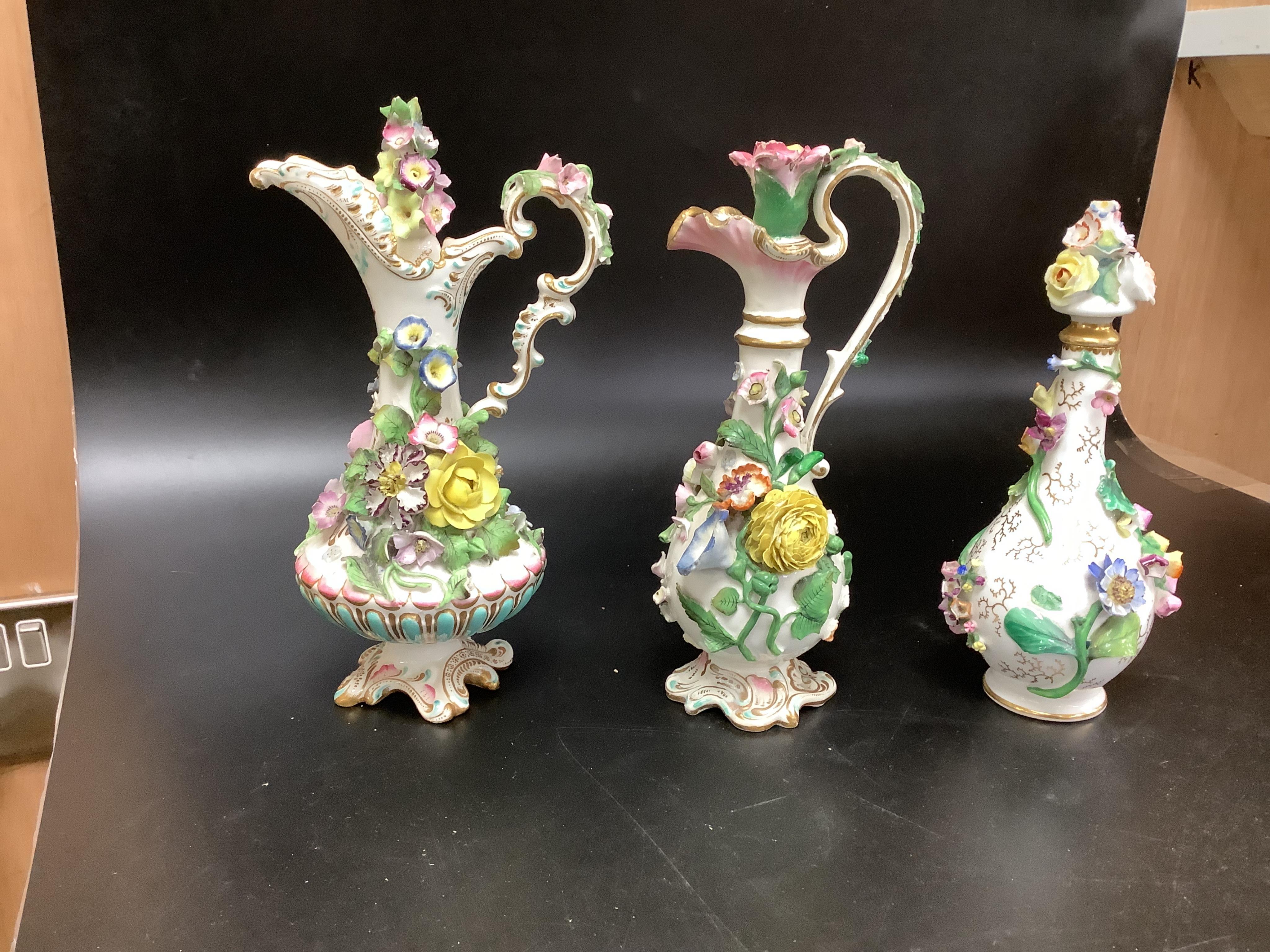 A group of English porcelain flower encrusted scent bottles and yours, Coalport, Minton etc., c.1830-50 together with Continental porcelain figures a wall pocket etc, largest 26cm high